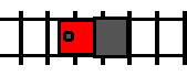 A train, facing left, traveling rightward along a track by backing up.
